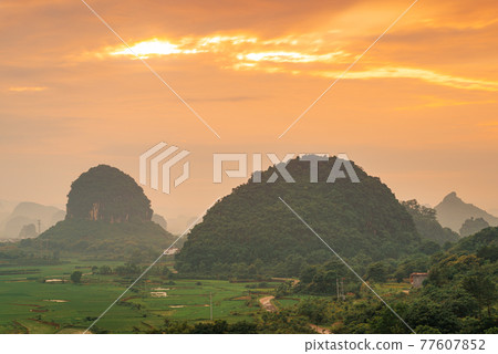 Guilin, China Karst Mountain landscape at Dusk 77607852
