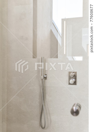 Chrome shower set on tiled wall Chrome shower set on tiled wall 77608677