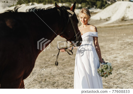 Portrait of a beautiful bride with horse Portrait of a beautiful bride with horse 77608833