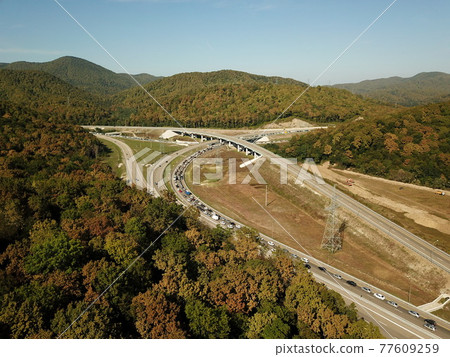 Autumn aerial image of transport junction, traffic cross road junction day view from above. Top down view of traffic jam. Autumn aerial image of transport junction, traffic cross road junction day view from above. Top down view of traffic jam. 77609259