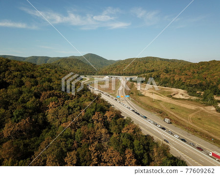 Autumn aerial image of transport junction, traffic cross road junction day view from above. Top down view of traffic jam. Autumn aerial image of transport junction, traffic cross road junction day view from above. Top down view of traffic jam. 77609262