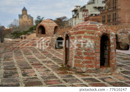 Popular city landmark in Tbilisi. Ancient underground complex of sulfur baths Popular city landmark in Tbilisi. Ancient underground complex of sulfur baths 77610247