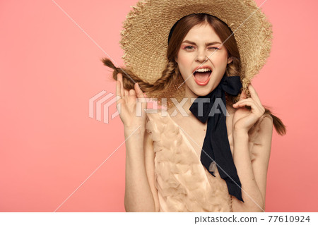 Beautiful woman in hat and in black dress ribbon portrait pink background model Beautiful woman in hat and in black dress ribbon portrait pink background model 77610924