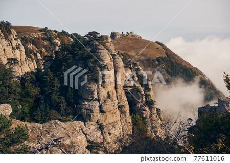 Grand stone pillars on the slopes of Mount Demerdzhi. Valley of ghosts, Crimean Mountains. Grand stone pillars on the slopes of Mount Demerdzhi. Valley of ghosts, Crimean Mountains. 77611016