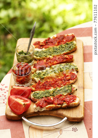 hot chili tomato and pesto sauce, sliced roasted italian ciabatta bread for cooking bruschetta sandwiches 77611102