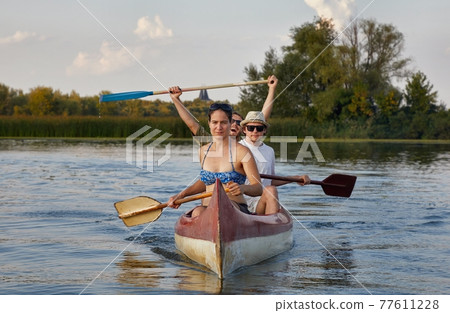 Canoeing on a lake Canoeing on a lake 77611228