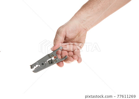 Hand holds a wire stripper on a white background 77611269