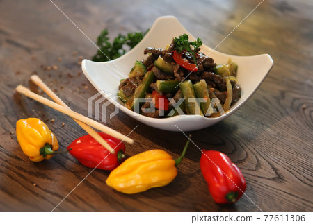 Salad with cucumbers. peppers and beef. Spicy Korean-style salad. Salad with cucumbers. peppers and beef. Spicy Korean-style salad. 77611306