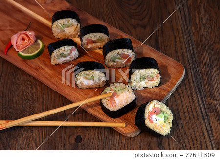 hot roll set sashimi japanese food on wooden background with lemon and chopsticks 77611309