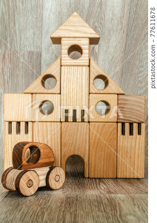 Conceptual photography, wooden figures of a house and a car. Conceptual photography, wooden figures of a house and a car. 77611678