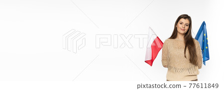 Young girl with the flag of the European Union and Poland. The student is holding two flags in her hand. Woman with flags on white background. Panoramic frame. Young girl with the flag of the European Union and Poland. The student is holding two flags in her hand. Woman with flags on white background. Panoramic frame. 77611849