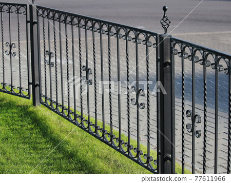 neat fence on the territory of city streets 77611966