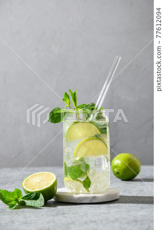 Mojito with lime, mint and ice cube on gray background. 77612094