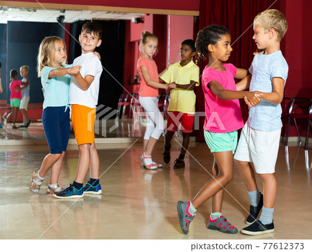 Children trying partner dance in class 77612373