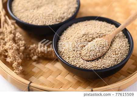 Brown quinoa seeds in a bowl with spoon, Edible seeds are high protein, Healthy food 77615509