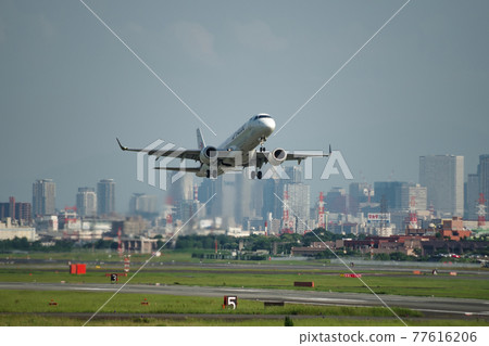 Jetliner taking off with the streets of Itami Airport, Osaka 77616206