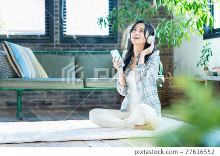Women's lifestyle smartphone headphones music living room new normal Women's lifestyle smartphone headphones music living room new normal 77616552
