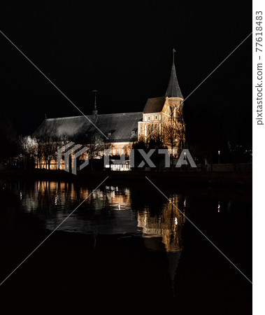 Konigsberg Cathedral in Kaliningrad at night and its reflection in the river Konigsberg Cathedral in Kaliningrad at night and its reflection in the river 77618483
