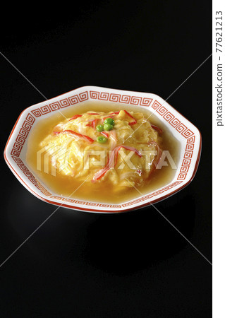 Chinese style omelet rice with red bean paste, Tianjin rice shot on a black background Chinese style omelet rice with red bean paste, Tianjin rice shot on a black background 77621213