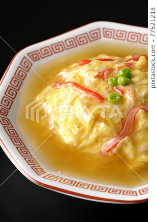 Chinese style omelet rice with red bean paste, Tianjin rice shot on a black background 77621218