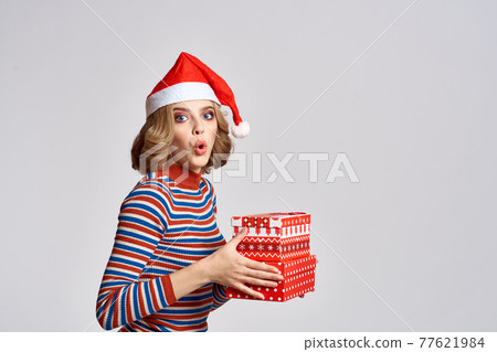 happy woman with christmas gifts in hands and red hat on head new year holidays cropped view happy woman with christmas gifts in hands and red hat on head new year holidays cropped view 77621984