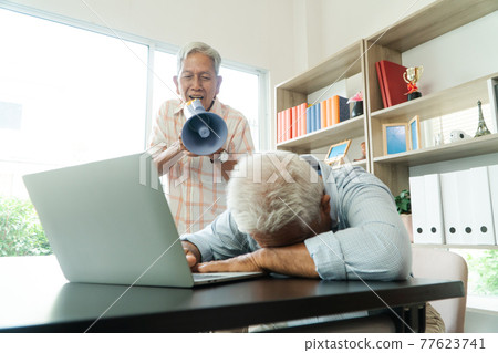 Old Asian elderly yell to a megaphone to talk with a friend for communication. Concept of communication problem in aging cause of ear be without hearing, deaf Old Asian elderly yell to a megaphone to talk with a friend for communication. Concept of communication problem in aging cause of ear be without hearing, deaf 77623741