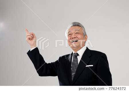Senior male business pointing 77624372
