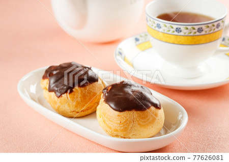 Tea time with handmade chocolate cream puffs Tea time with handmade chocolate cream puffs 77626081