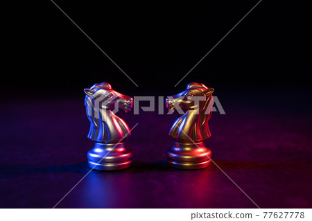 Golden and silver horse chess pieces Invite face to face and There are chess pieces in the background. Concept of competing, leadership and business vision for a win in business games Golden and silver horse chess pieces Invite face to face and There are chess pieces in the background. Concept of competing, leadership and business vision for a win in business games 77627778