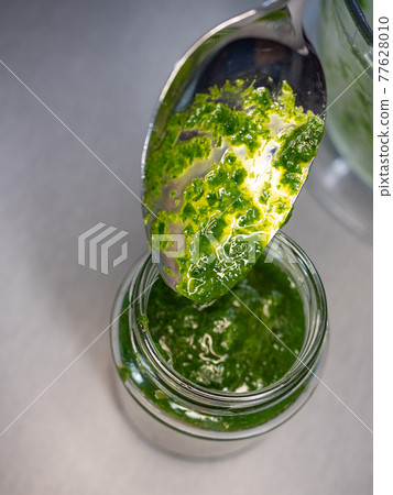Fresh home made wild garlic pesto. Close up view of pesto sauce Fresh home made wild garlic pesto. Close up view of pesto sauce 77628010