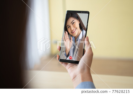 Asian doctor or therapist help relieve stress and provide knowledge and understanding about office syndrome to patients video conference call online live talk remotely at home by smartphone Asian doctor or therapist help relieve stress and provide knowledge and understanding about office syndrome to patients video conference call online live talk remotely at home by smartphone 77628215