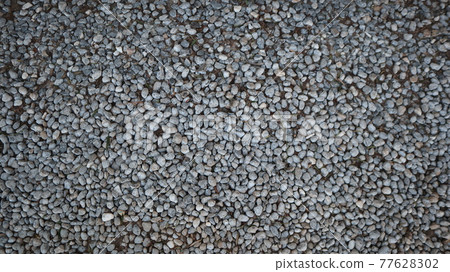 Texture of little stones in many shades of grey and white laying on ground. Stone floor texture for background. Crack Stone pattern at a construction site in Turkey 77628302