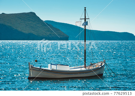 Traditional greek fishing boat in the aegean sea, Greece. Traditional greek fishing boat in the aegean sea, Greece. 77629513