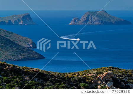 Speeding speed boat catamaran ship in Aegean sea near Milos island in Greece 77629558