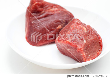 fresh raw beef meat pieces on white plate. fresh raw beef meat pieces on white plate. 77629607