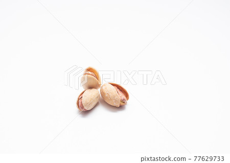 Pistachios isolated on a white background. Salted Pistachio nuts. Pistachios isolated on a white background. Salted Pistachio nuts. 77629733