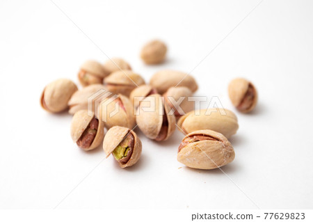 Pile of pistachios on a white background. Set of Pistachio nuts 77629823