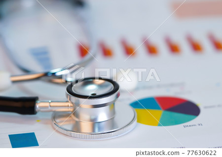 Stethoscope on chart or graph paper, Financial, account, statistics and business data  medical health concept.. 77630622