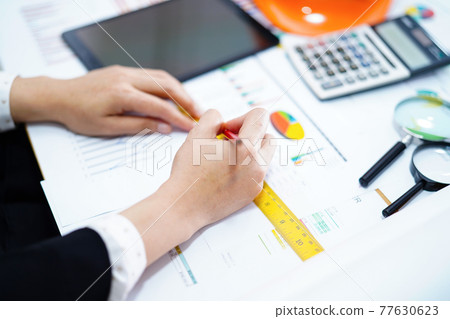 Architect or engineer working project accounting with graph with tools in office, Construction account concept. Architect or engineer working project accounting with graph with tools in office, Construction account concept. 77630623