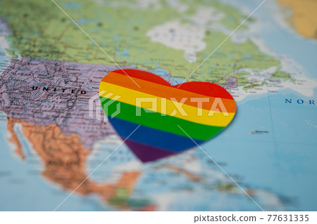 Rainbow color heart on America globe world map background, symbol of LGBT pride month  celebrate annual in June social, symbol of gay, lesbian, gay, bisexual, transgender, human rights and peace. 77631335