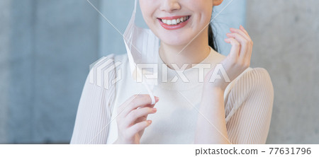 A banner size below the nose of a young woman who smiles with her mask on her ears 77631796