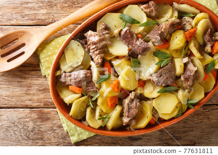 Alsace Baeckeoffe Casserole with meat, potatoes and vegetables, marinated with white wine close-up in a pot. Horizontal top view 77631811
