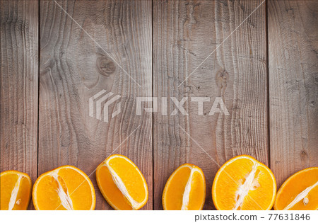 Organic orange fruit. Slices on wooden background. Selective focus 77631846