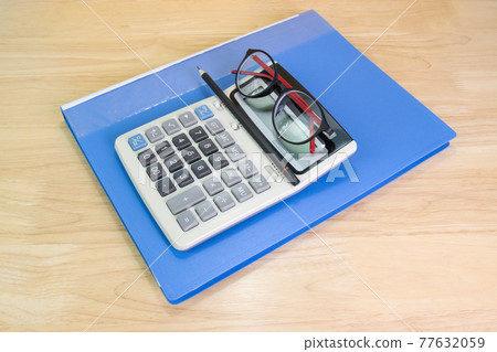 pencil, calculator, Blue file, glasses on white wood table concept Office equipment pencil, calculator, Blue file, glasses on white wood table concept Office equipment 77632059