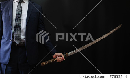 一個穿著西裝拿著日本劍的人 一個穿著西裝拿著日本劍的人 77633344