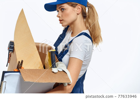 Woman working with box in hands of tools delivery service light background 77633946