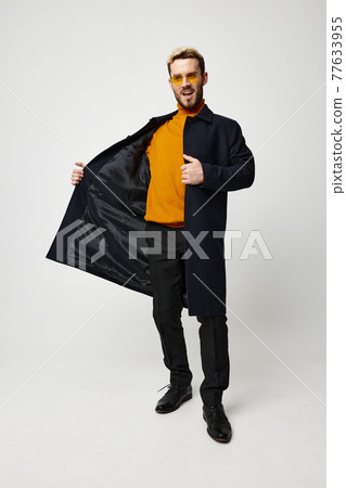 man in dark coat and pants orange sweater fashion style and glasses model man in dark coat and pants orange sweater fashion style and glasses model 77633955