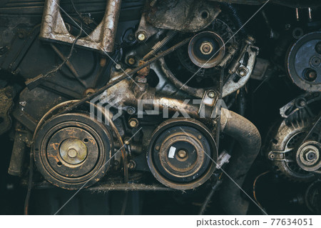 old car engine spare part used closeup Serpentine belt vehicle machine dirty grease grunge with oil in garage. old car engine spare part used closeup Serpentine belt vehicle machine dirty grease grunge with oil in garage. 77634051