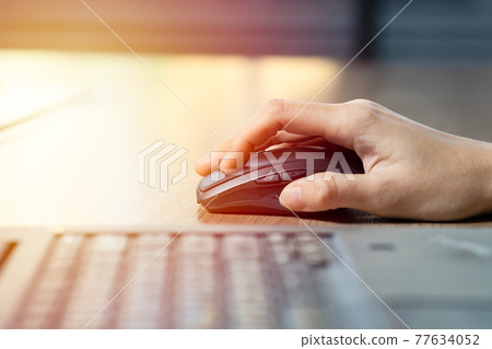Close up of business woman hand using mouse with computer laptop for working in office. 77634052