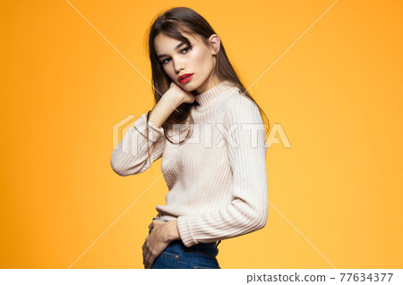 Cute brunette red lips fashionable clothes studio yellow background Cute brunette red lips fashionable clothes studio yellow background 77634377